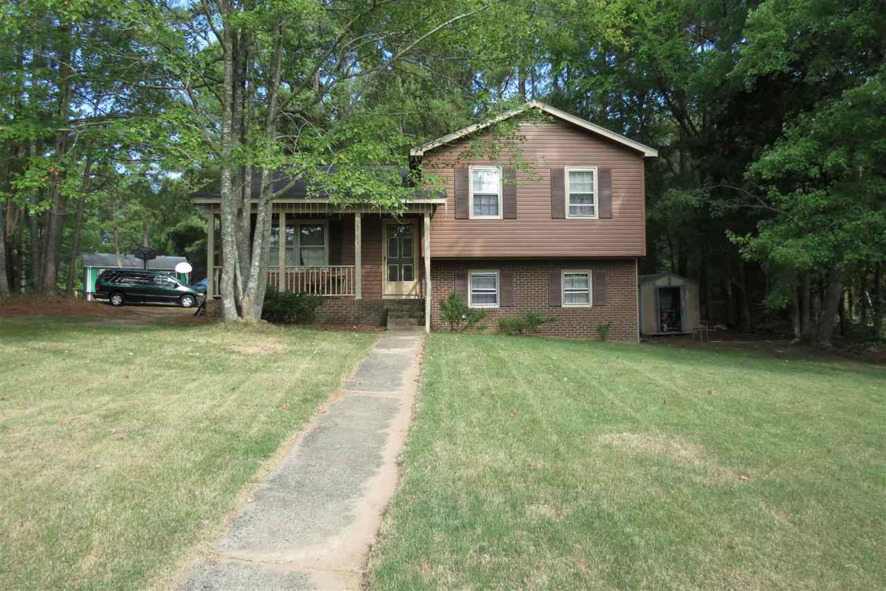 5114 McCormick Road Durham, NC 27713 - Photo 1 of 25 a front view of a house with a garden and trees