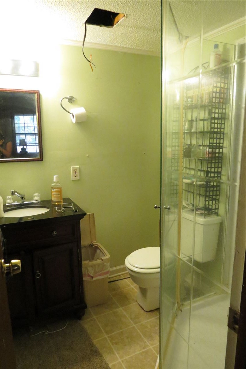5114 McCormick Road Durham, NC 27713 - Photo 19 of 25 a bathroom with a sink toilet and shower