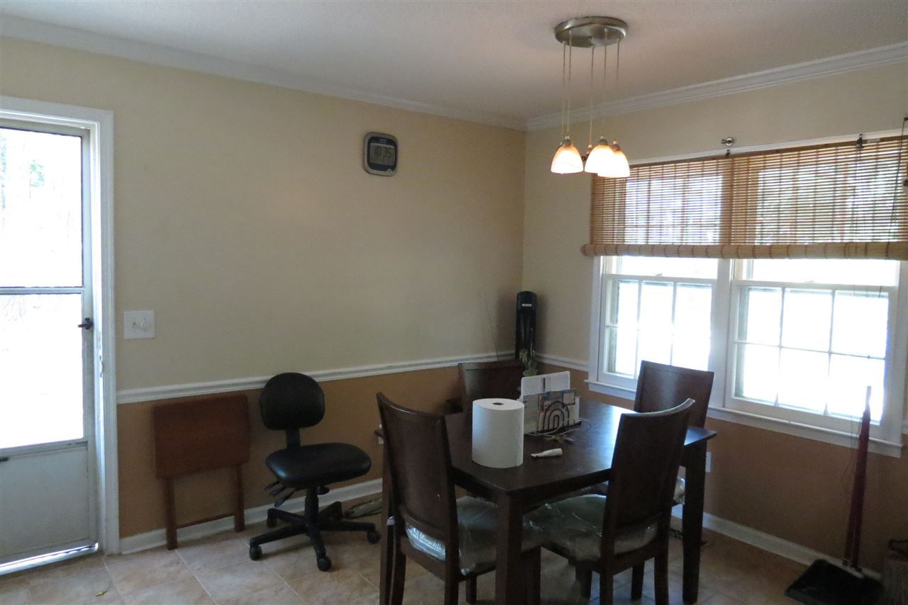 5114 McCormick Road Durham, NC 27713 - Photo 23 of 25 a view of a dining room with furniture and a window