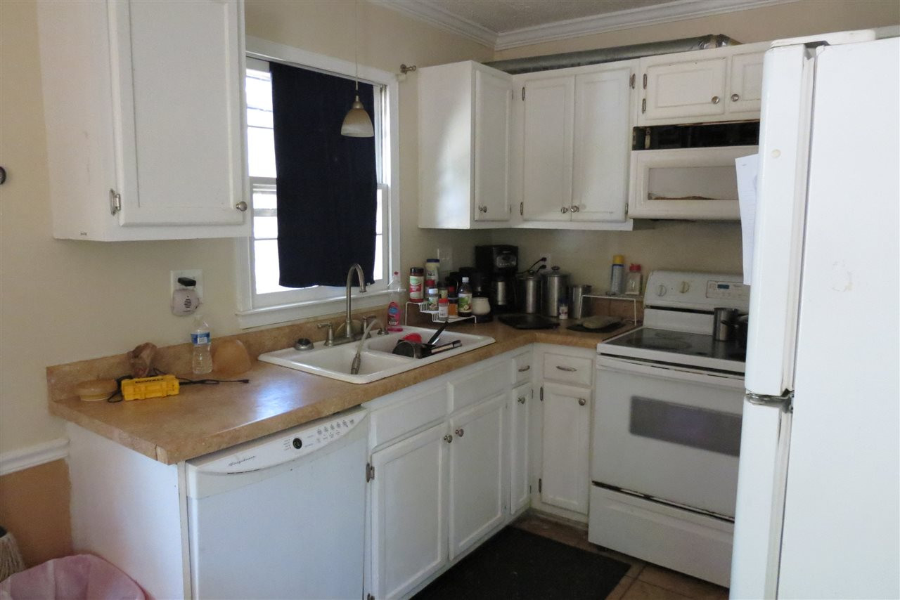 5114 McCormick Road Durham, NC 27713 - Photo 25 of 25 a kitchen with white cabinets and white appliances