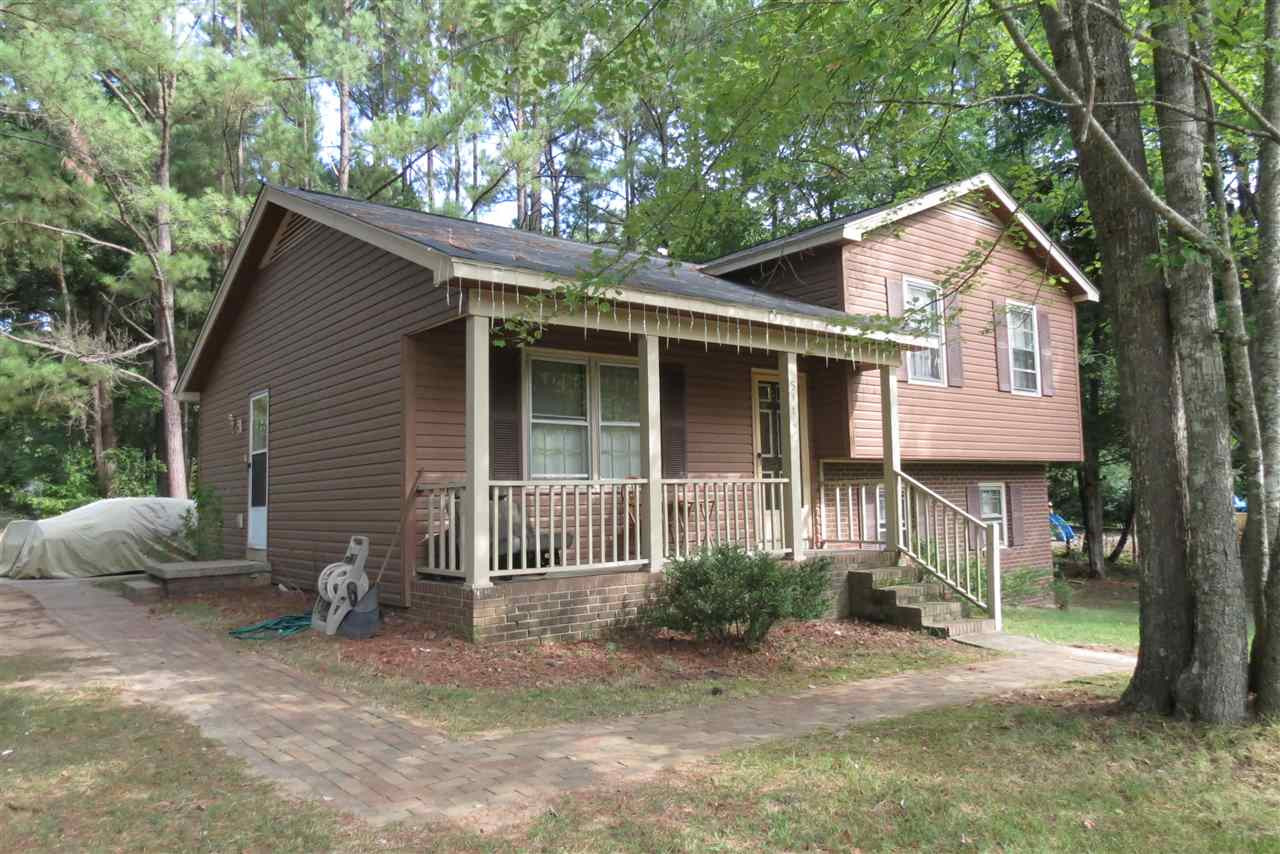 5114 McCormick Road Durham, NC 27713 - Photo 4 of 25 a front view of a house with a yard and garage