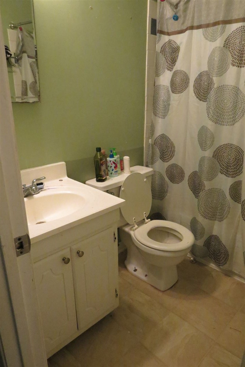 5114 McCormick Road Durham, NC 27713 - Photo 6 of 25 a bathroom with a toilet a sink and mirror