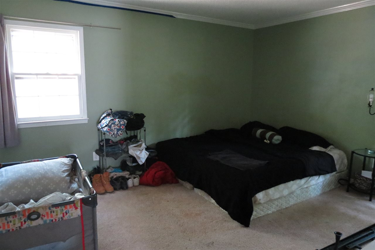 5114 McCormick Road Durham, NC 27713 - Photo 7 of 25 a bed sitting in a bedroom next to a window