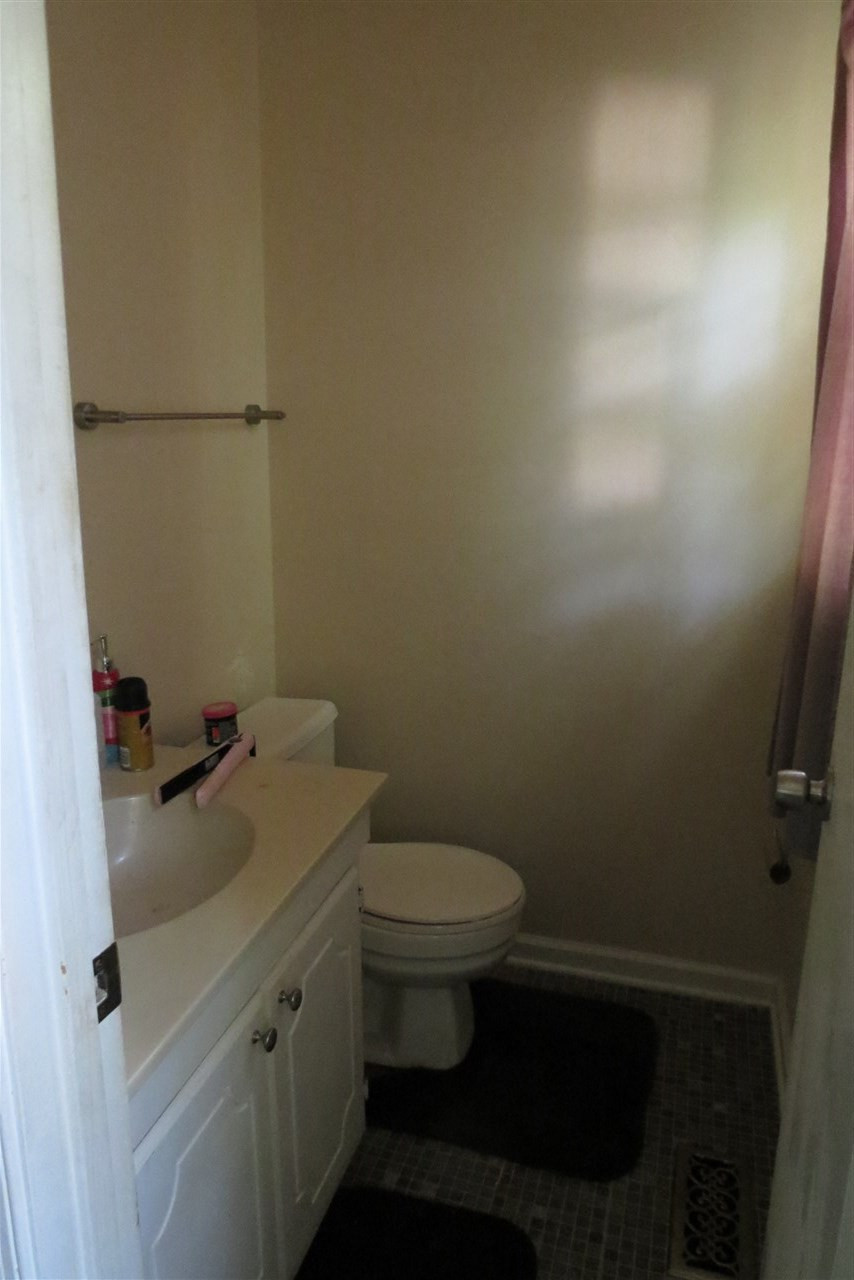 5114 McCormick Road Durham, NC 27713 - Photo 8 of 25 a bathroom with a toilet and a sink