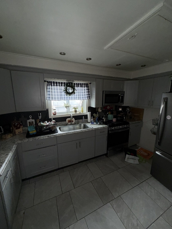496 Tucker Street Fall River, MA 02721 - Photo 2 of 19 a kitchen with a sink a counter top space cabinets and stainless steel appliances