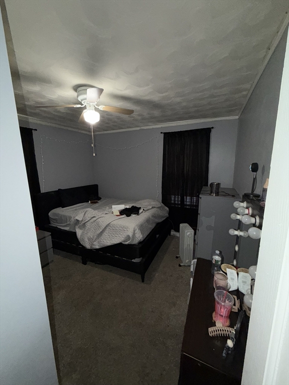496 Tucker Street Fall River, MA 02721 - Photo 7 of 19 a bed sitting in a room next to a window