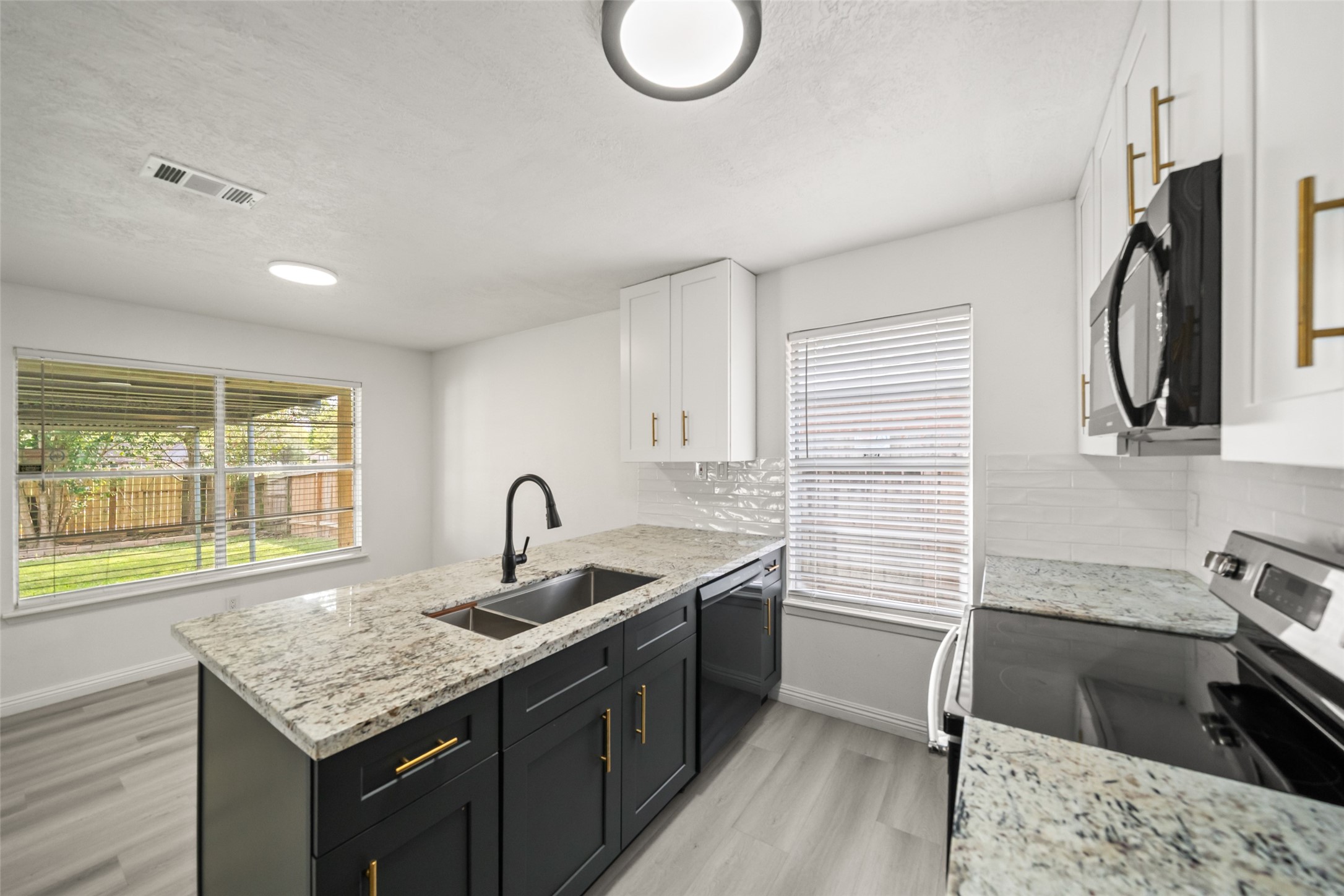 5726 Yorkgate Drive Spring, TX 77373 - Photo 12 of 20 a kitchen with a sink stove and cabinets