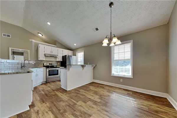 a view of a kitchen with stove and microwave