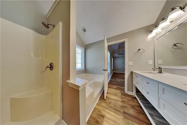 a bathroom with a double vanity sink and mirror with shower