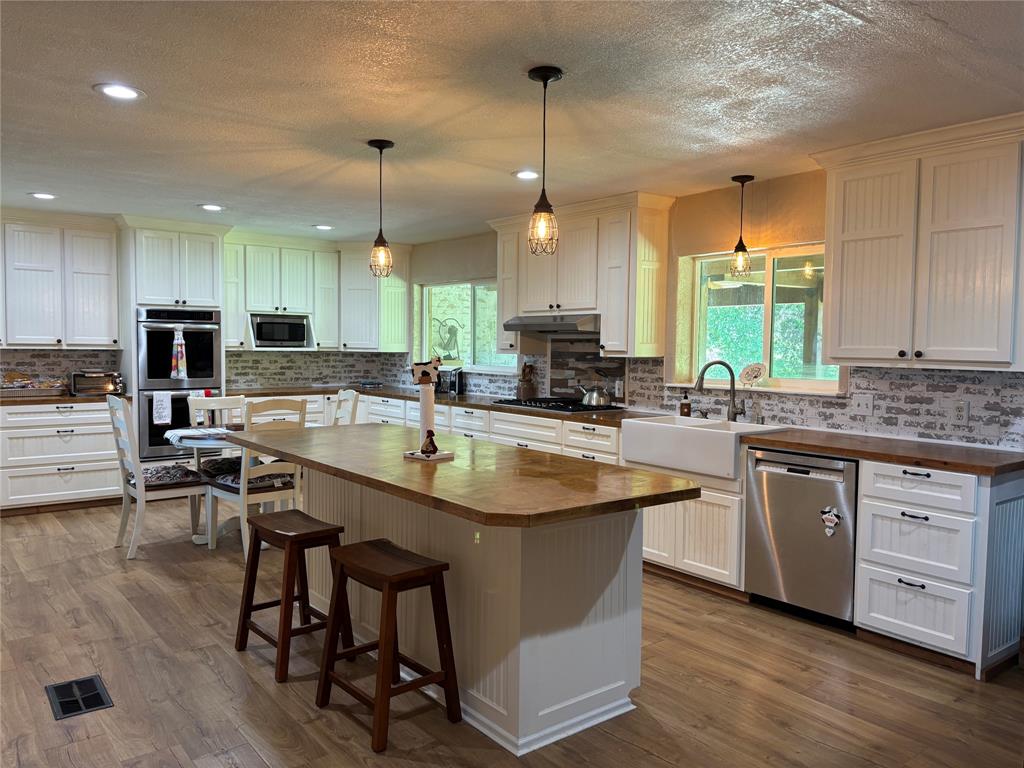 5355 Banks Road Fort Worth, TX 76140 - Photo 14 of 24 a kitchen with kitchen island granite countertop a sink a counter top space appliances and a window