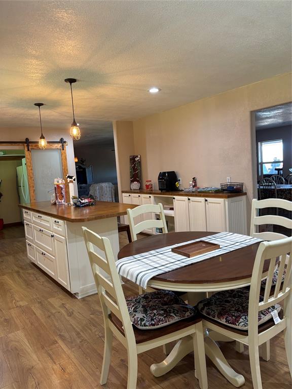 5355 Banks Road Fort Worth, TX 76140 - Photo 15 of 24 a dining hall with stainless steel appliances kitchen island granite countertop a dining table chairs and granite counter tops