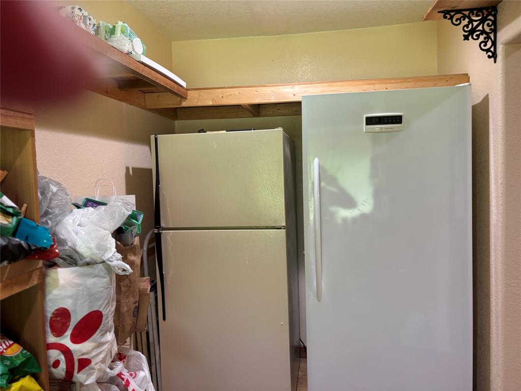 5355 Banks Road Fort Worth, TX 76140 - Photo 18 of 24 a white refrigerator freezer sitting inside of a kitchen