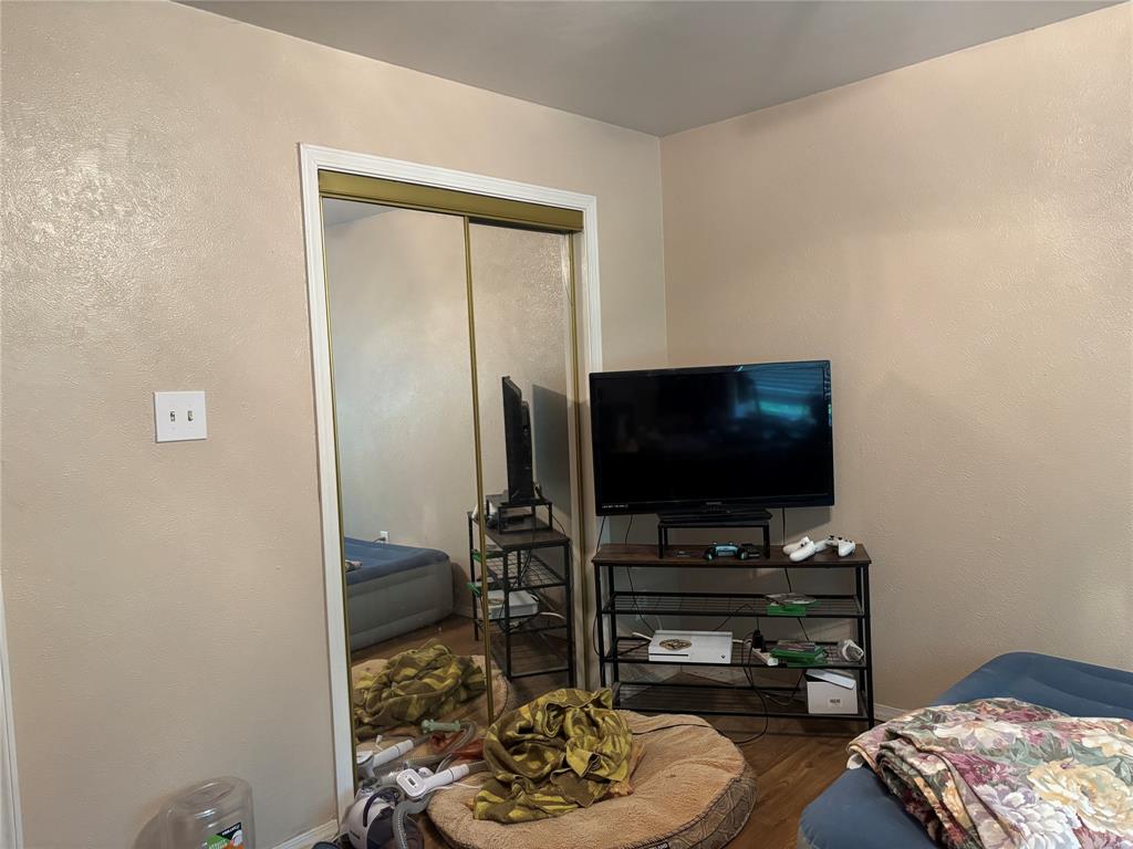 5355 Banks Road Fort Worth, TX 76140 - Photo 19 of 24 a living room with furniture and a flat screen tv