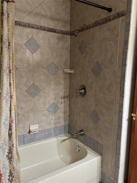 5355 Banks Road Fort Worth, TX 76140 - Photo 20 of 24 a white bath tub and a shower