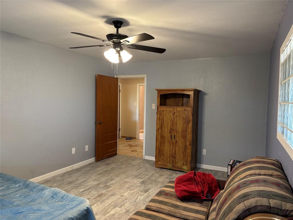 5355 Banks Road Fort Worth, TX 76140 - Photo 23 of 24 a bedroom with a bed and a chandelier