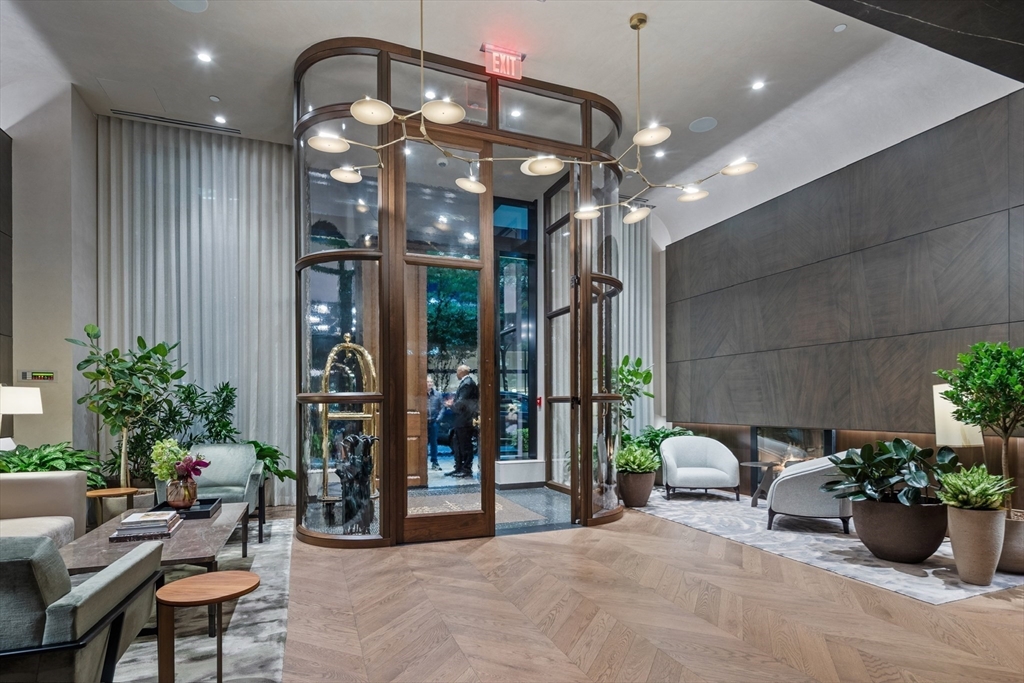 40 Trinity Place, Unit U25D Boston, MA 02116 - Photo 11 of 12 a living room with furniture and potted plants