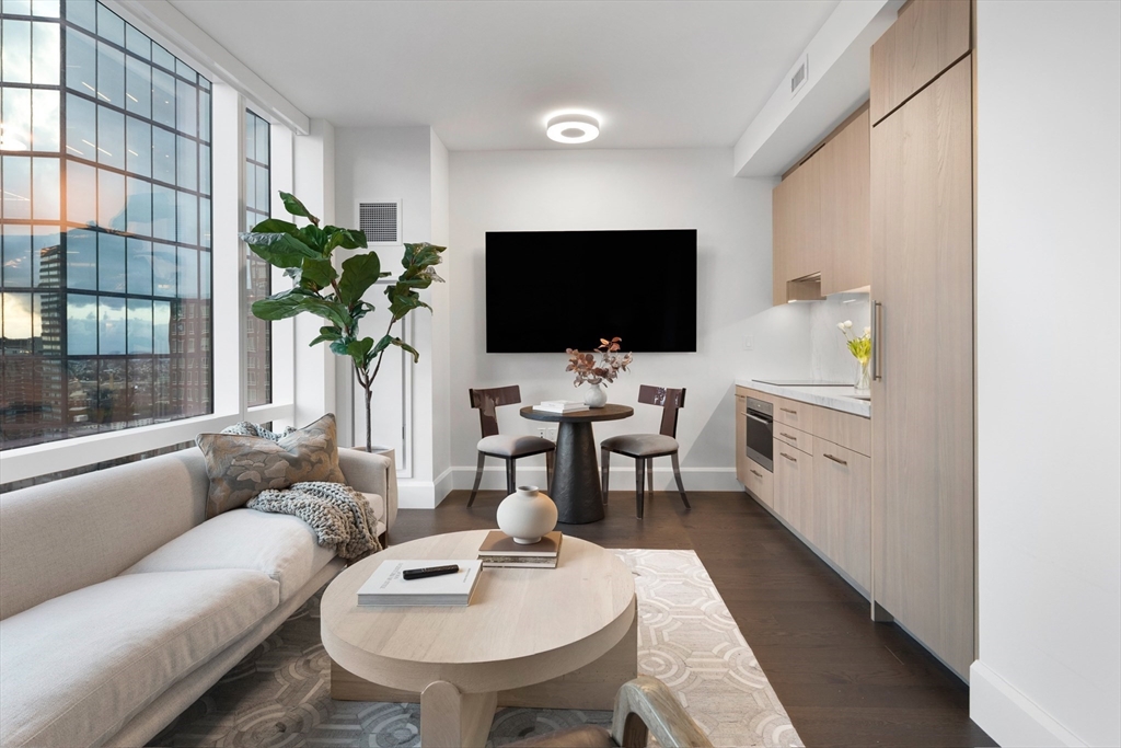 40 Trinity Place, Unit U25D Boston, MA 02116 - Photo 3 of 12 a living room with furniture and a flat screen tv