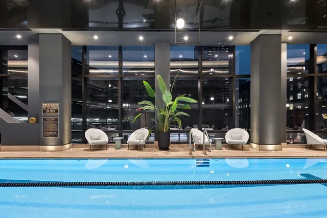 a living room with furniture and potted plants