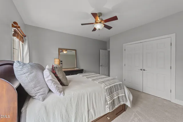 an aerial view of a residential apartment building with a yard and outdoor seating