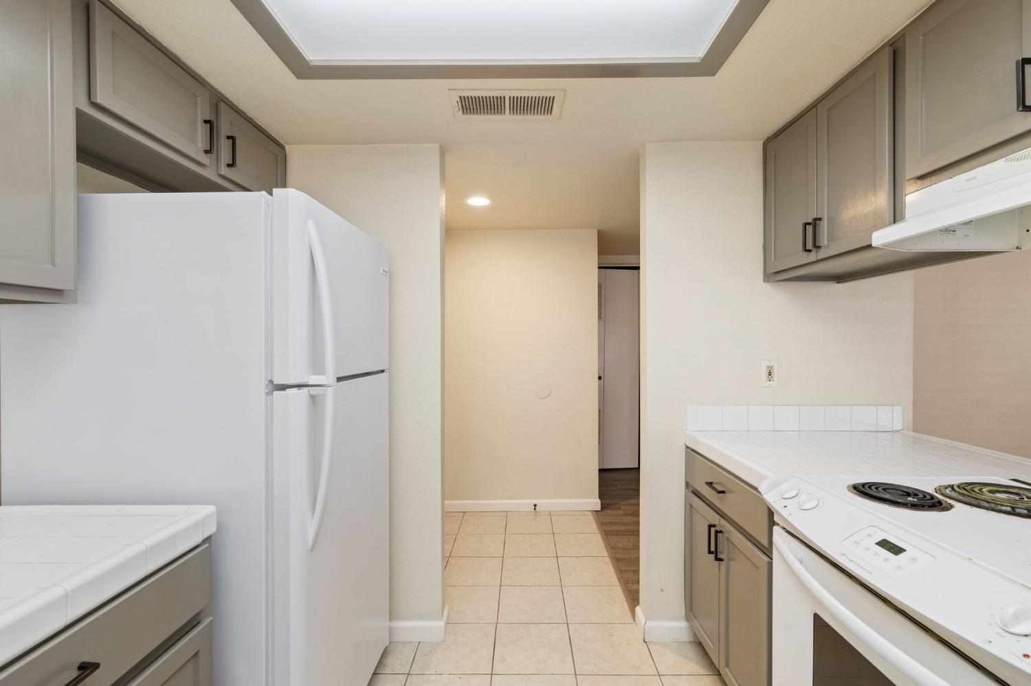 7675 North First Street, Unit 136 Fresno, CA 93720 - Photo 11 of 40 a kitchen with a stove and a refrigerator