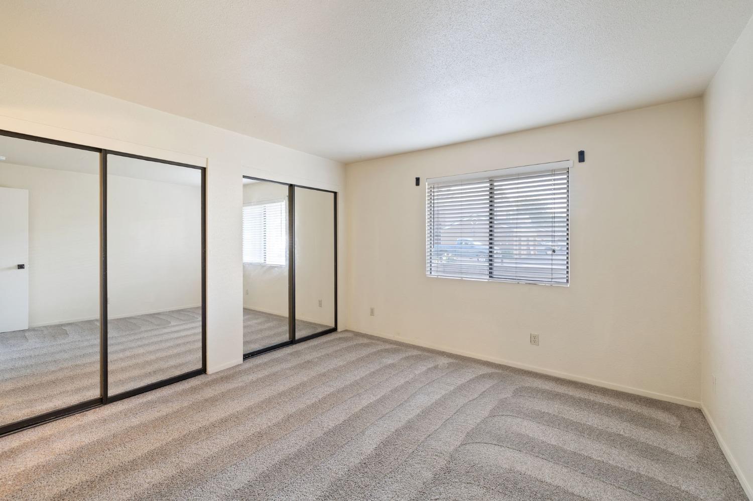 7675 North First Street, Unit 136 Fresno, CA 93720 - Photo 17 of 40 an empty room with windows
