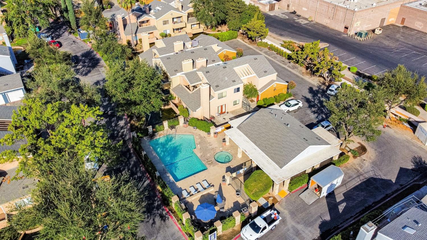7675 North First Street, Unit 136 Fresno, CA 93720 - Photo 3 of 40 an aerial view of a house with a yard and outdoor seating