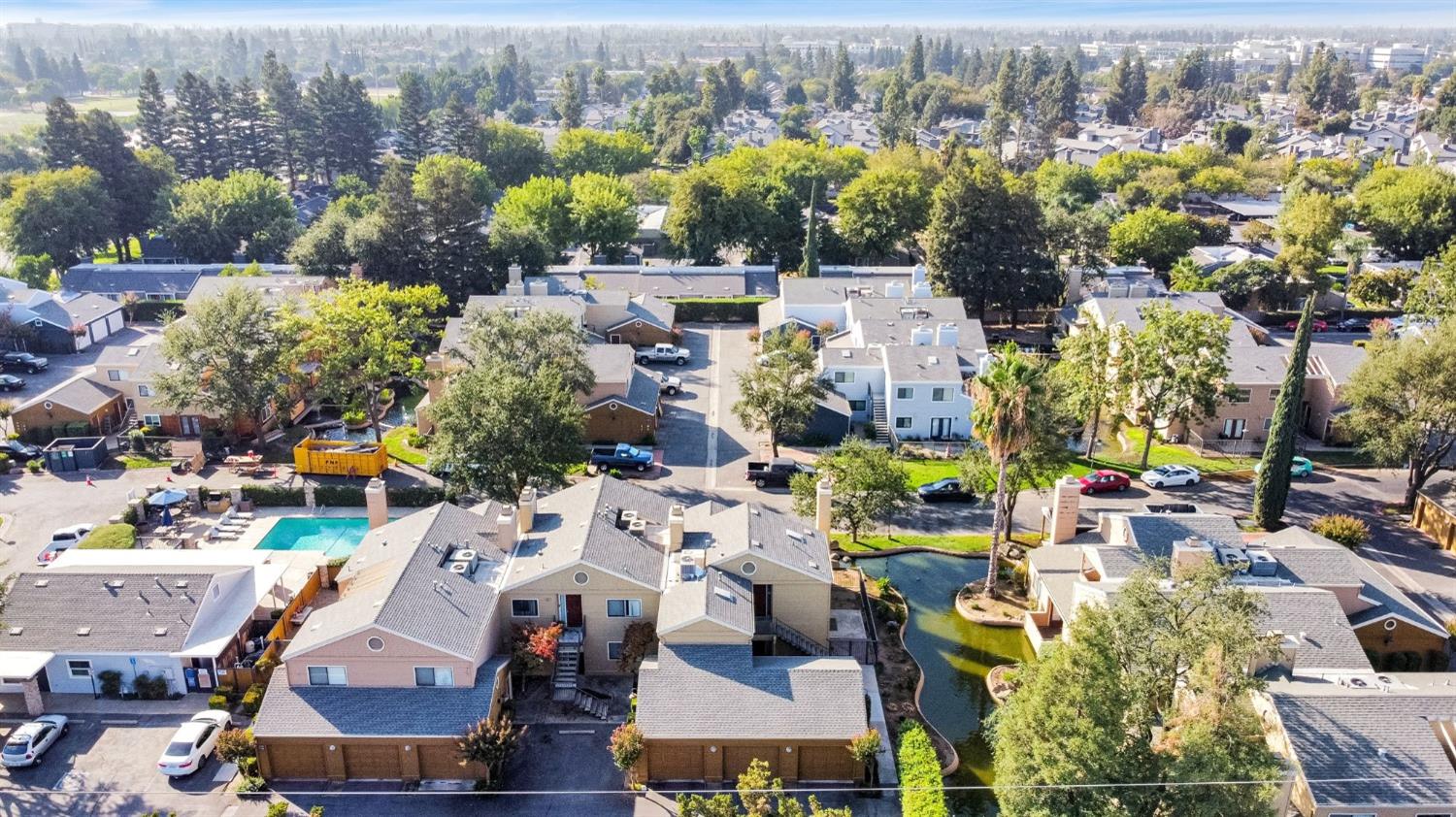 7675 North First Street, Unit 136 Fresno, CA 93720 - Photo 32 of 40 an aerial view of a houses with a swimming pool