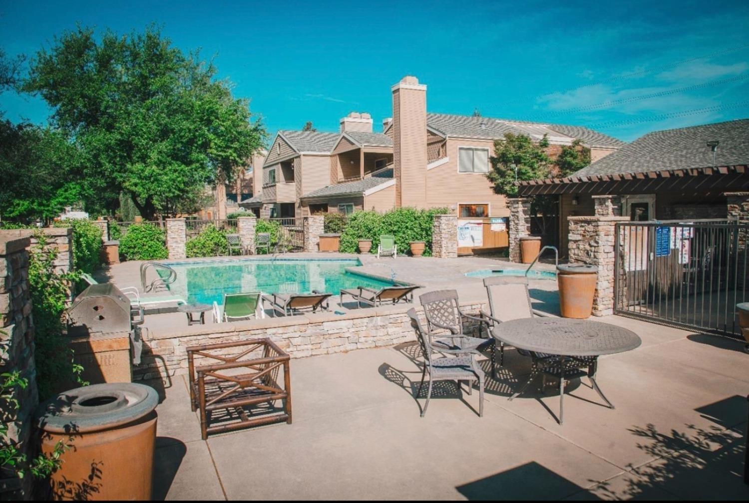 7675 North First Street, Unit 136 Fresno, CA 93720 - Photo 37 of 40 a view of a patio with a table and chairs