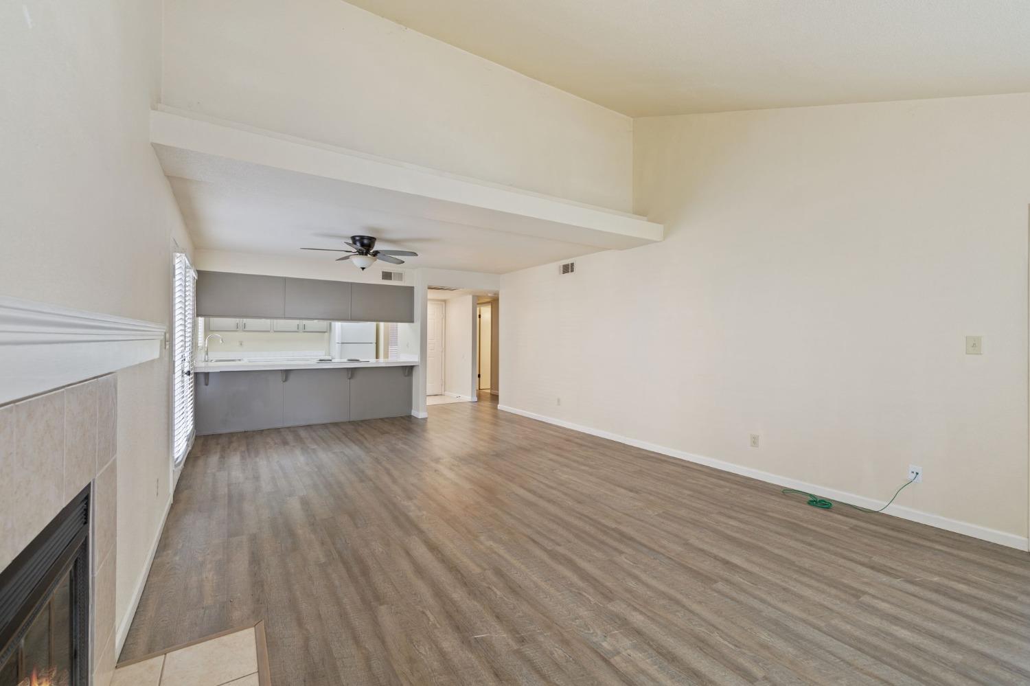 7675 North First Street, Unit 136 Fresno, CA 93720 - Photo 8 of 40 a view of an empty room with a window and wooden floor