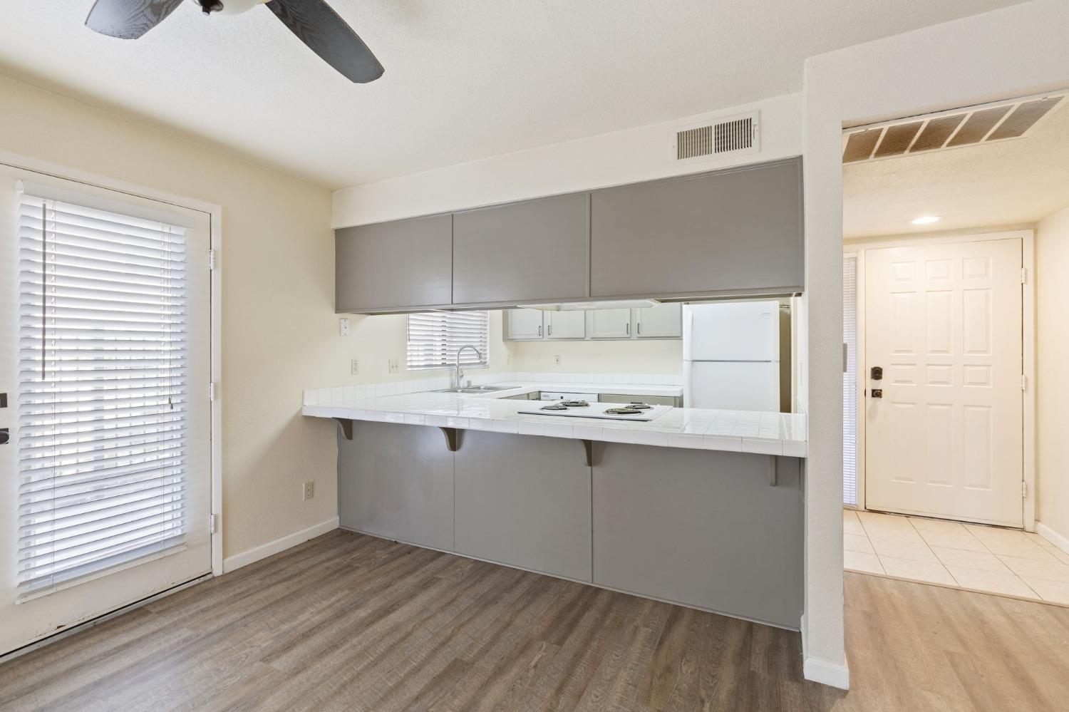 7675 North First Street, Unit 136 Fresno, CA 93720 - Photo 9 of 40 a kitchen with a sink cabinets and wooden floor