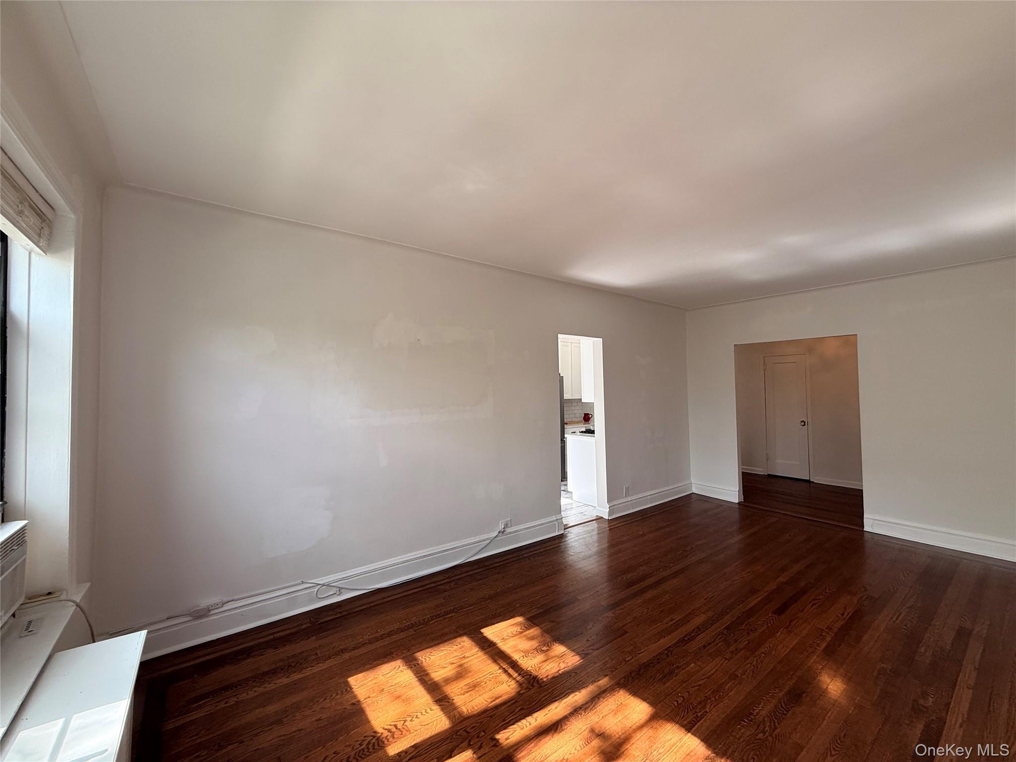 143 Garth Road, Unit 3L Scarsdale, NY 10583 - Photo 9 of 37 Living room with kitchen entry and long hallway entrance
