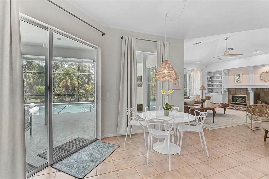 2050 Timucua Trail Nokomis, FL 34275 - Photo 16 of 50 a dining room with furniture a chandelier and fireplace