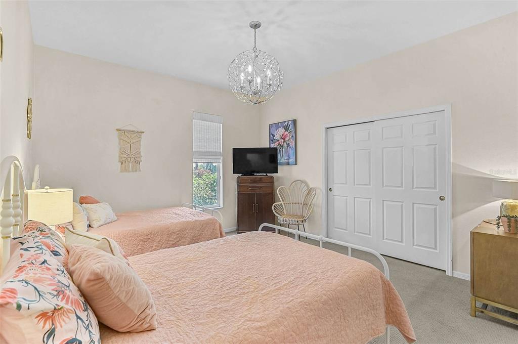 2050 Timucua Trail Nokomis, FL 34275 - Photo 25 of 50 a bedroom with a bed and a flat tv screen on dresser