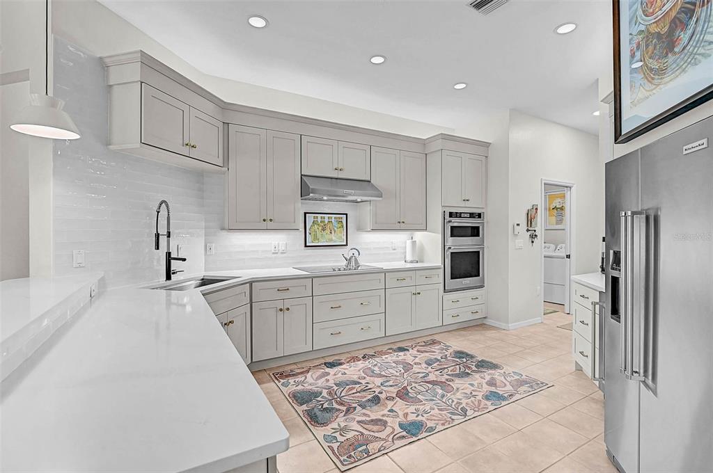 2050 Timucua Trail Nokomis, FL 34275 - Photo 8 of 50 a kitchen with kitchen island wooden cabinets and refrigerator