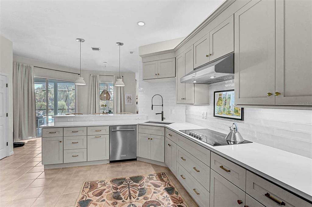 2050 Timucua Trail Nokomis, FL 34275 - Photo 10 of 50 a large white kitchen with stainless steel appliances granite countertop a sink and cabinets