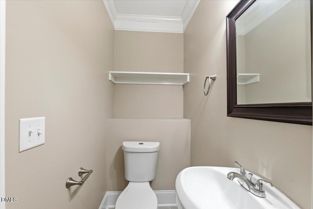 2402 Green Street Durham, NC 27705 - Photo 21 of 25 a bathroom with a toilet sink and mirror