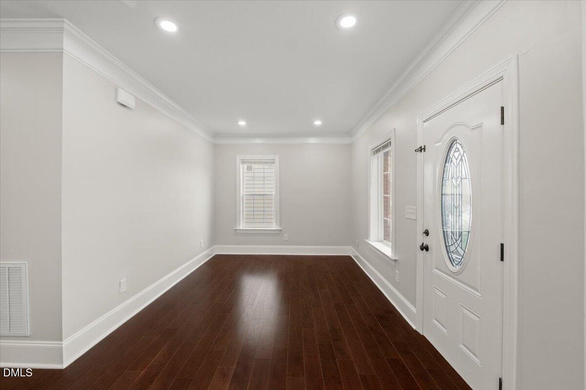 2402 Green Street Durham, NC 27705 - Photo 7 of 25 a view of a hallway with wooden floor and a window