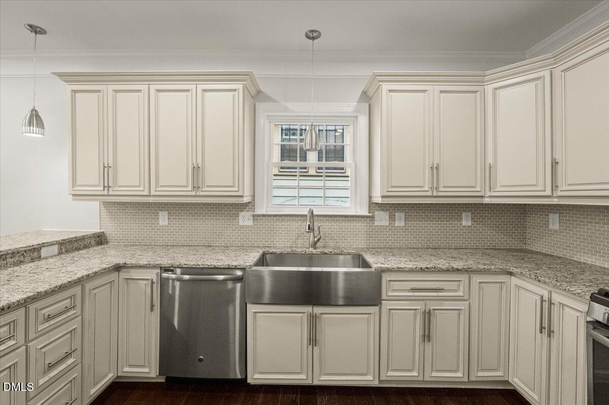 2402 Green Street Durham, NC 27705 - Photo 9 of 25 a kitchen with stainless steel appliances granite countertop a sink and cabinets with granite countertops