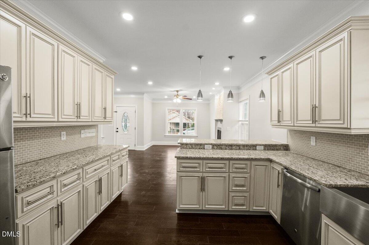 2402 Green Street Durham, NC 27705 - Photo 10 of 25 a large kitchen with stainless steel appliances granite countertop a stove and a sink