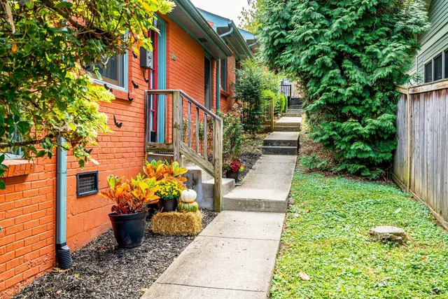 a front view of a house with a garden