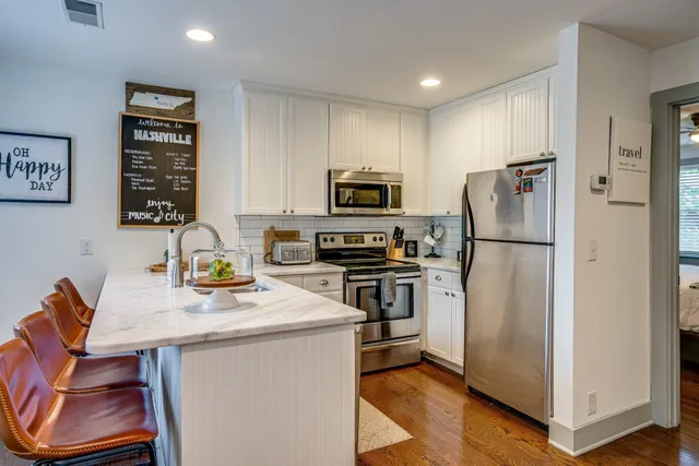 a kitchen with a refrigerator and a sink