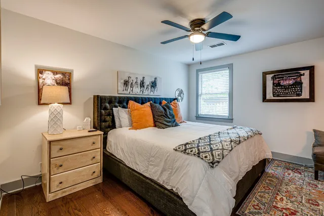 a bedroom with bed and a chandelier