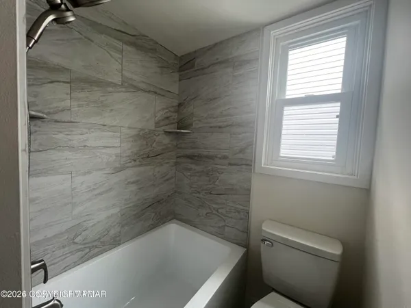 a bath tub sitting next to a toilet