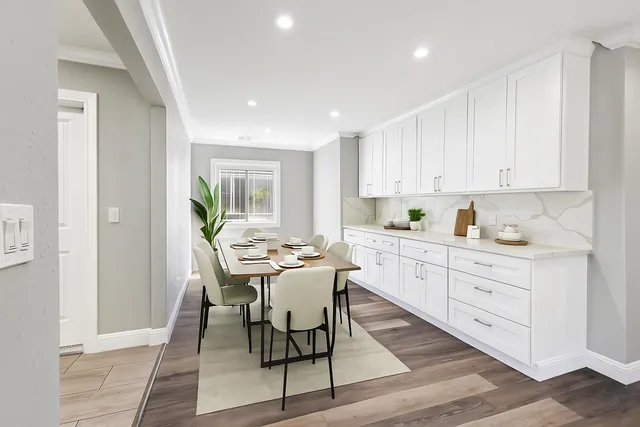 a kitchen with white cabinets and white appliances