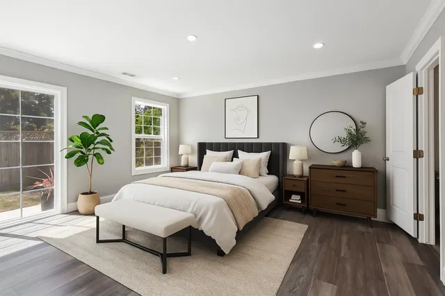 a spacious bedroom with a bed and a potted plant
