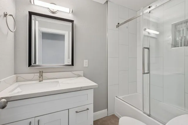 a bathroom with a sink toilet and shower