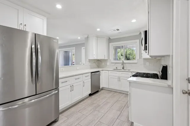 a kitchen with a refrigerator stove and sink