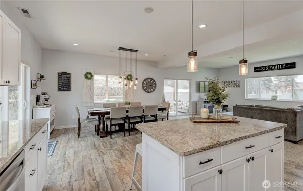a dining table with chairs in it and wooden floor
