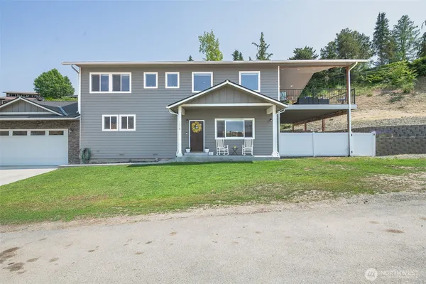 a front view of house with yard and green space