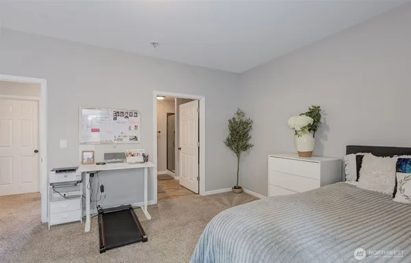 a en suite bathroom with a granite countertop tub sink and mirror